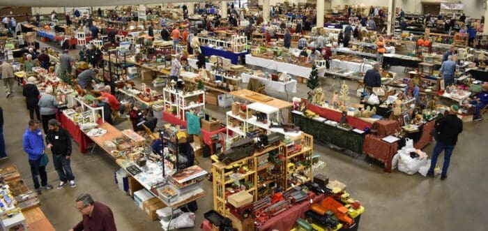 Crowd browsing antique toy booths at the 48th Allentown Antique Toy Show & Sale, with various vintage toys and collectibles on display.
