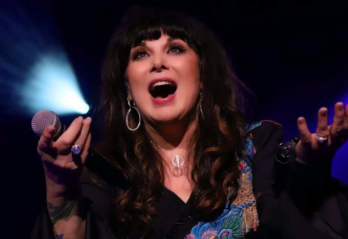 Easton Post image of Ann Wilson singing passionately on stage with a microphone, expressive face, and dynamic lighting highlighting her performance.