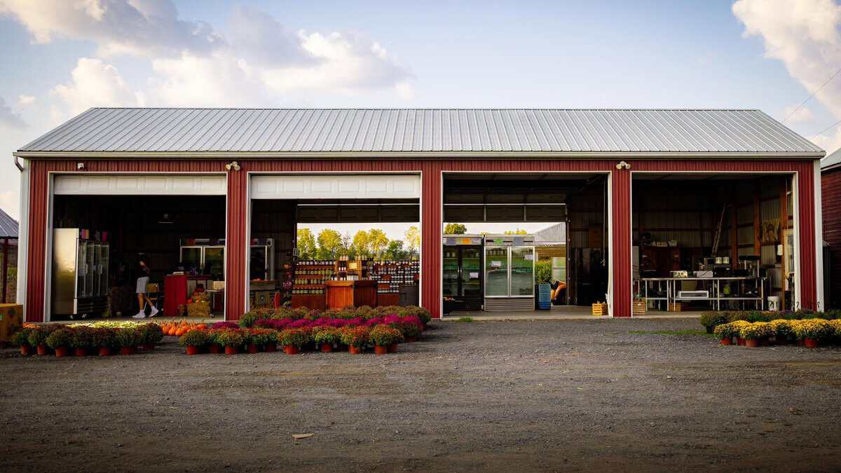 Exterior view of Raubs Farm Market during the 1st Annual Craft Show, showcasing vendor booths and colorful decorations outside the market building.