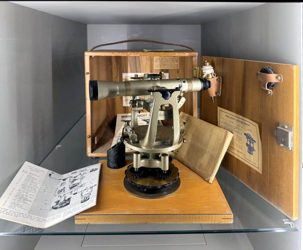 Historical military optical device with wooden case and instruction manual on display at Easton Post exhibit.
