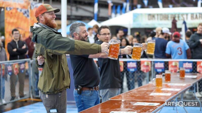 People enjoying beer at Oktoberfest at SteelStacks 2026, with a lively crowd and festive atmosphere.