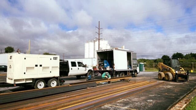 Railroad track maintenance equipment and vehicles on a cloudy day at Easton Post.